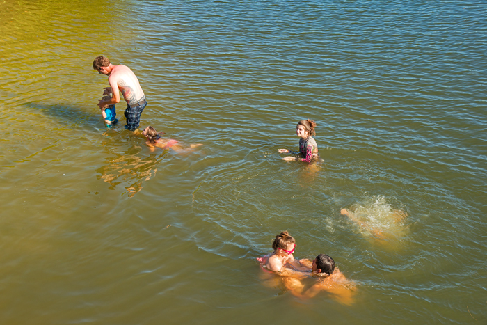A family swimming off Round Island in the Indian River Lagoon despite posted &quot;no swimming&quot; signs. 