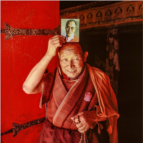 Tibetan Buddhist monk venerating His Holiness the Dalai Lama, Lhasa, Tibet, 1986. 