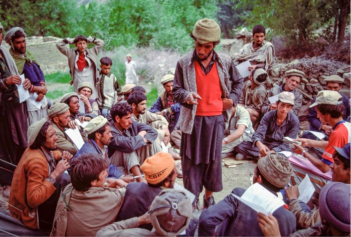 K2 porters receiving trek instructions from the head sirdar, Pakistan, 1986.