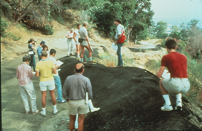 Walking tours, combined with field research, engage residents in gathering scientific and sensual evidence about special places. Here, a group measures the effects of erosion from poor siting of a road on their Hollywood, California, neighborhood. Citizen involvement reversed their previous support to dam this natural canyon and engineer a debris basin to control flooding. Their own science convinced them to disperse floodwater into sub-watersheds, slowing erosion with small check dams and vegetation.