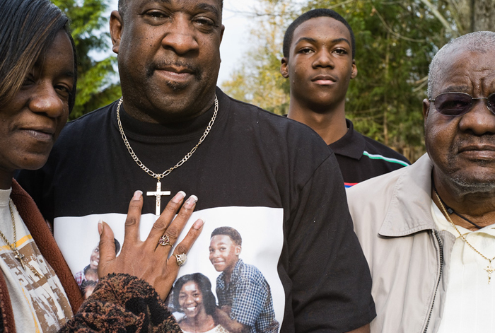 Marvin Charles, of Seattle, Washington, with his wife, son, and father.  (© Lewis Kostiner)
