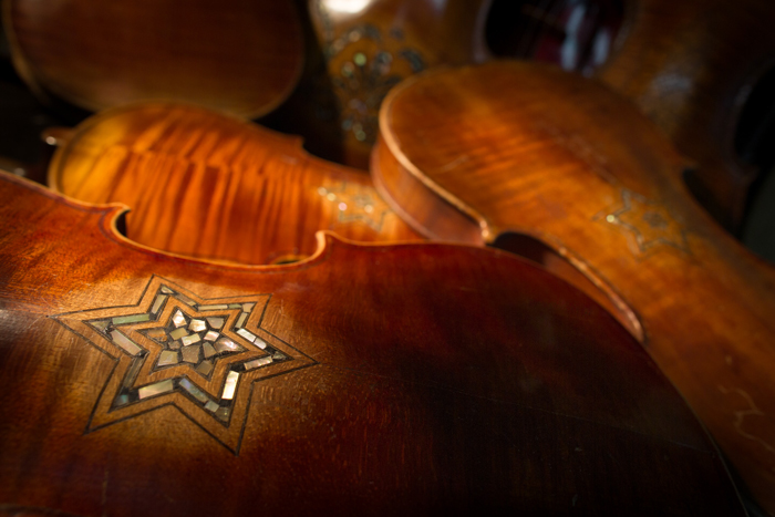 A sampling of Klezmer Holocaust violins on Amnon’s auxiliary workbench.