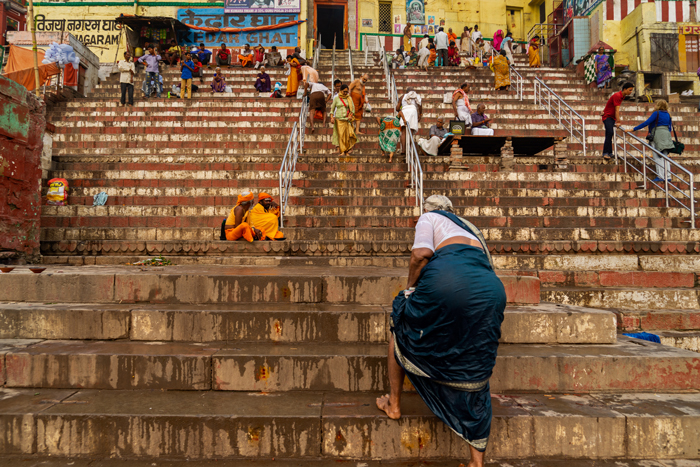 Kedar Ghat. A woman climbs the steep stairs of the ghat to Kedarnath Mandir, the ghatside Shiva temple.