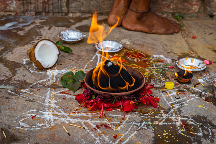 For most festivals and holy days, the exact ritual details performed will vary from family to family. Here, resinous incense and coconut are offered to God within a chalk-inscribed Yantra, a mystical diagram with ritual significance.