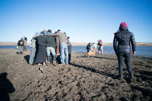 Water Protectors offer prayers at the “Returning the Stone” ceremony along the Missouri River.